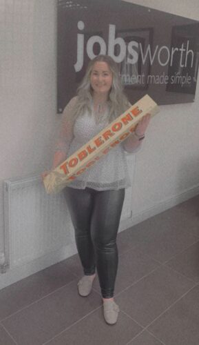 Charlotte celebrating her birthday with a Toblerone almost as tall as she is